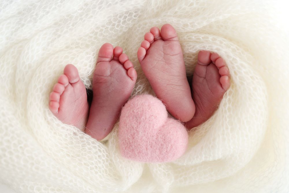 The feet of two babies born from twins.