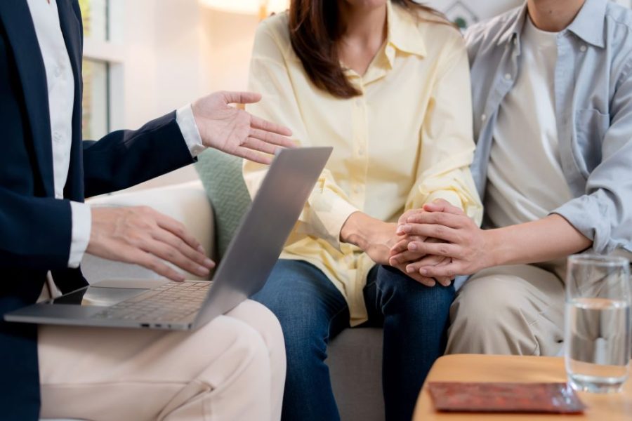Couples listen to advice from a doctor about pre-pregnancy health checks to prepare for having children.